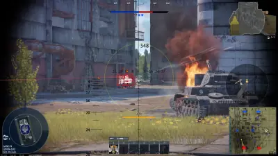 War Thunder urban ground battle with a burning vehicle beside the tank sight